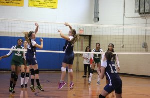 Jackie Fletcher and Sarah Frankel look to teammate Hailey Hartnett for a dig in their game against Long Branch High School on Oct. 15. Photo by Alexandria Principe 
