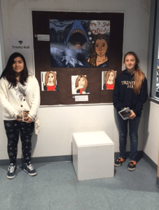 Pictured Two Students in front of art work done at Monmouth Teen Art Festival