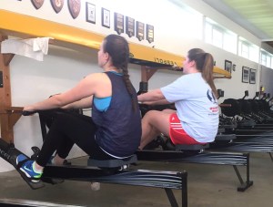 Freshmen Gretchen Richardson and Louise McCrone warm up on the erg before practice.  Photo by Isabella Palmeri
